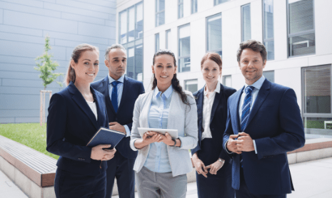 businesspeople-standing-outside-office-building (1)-min